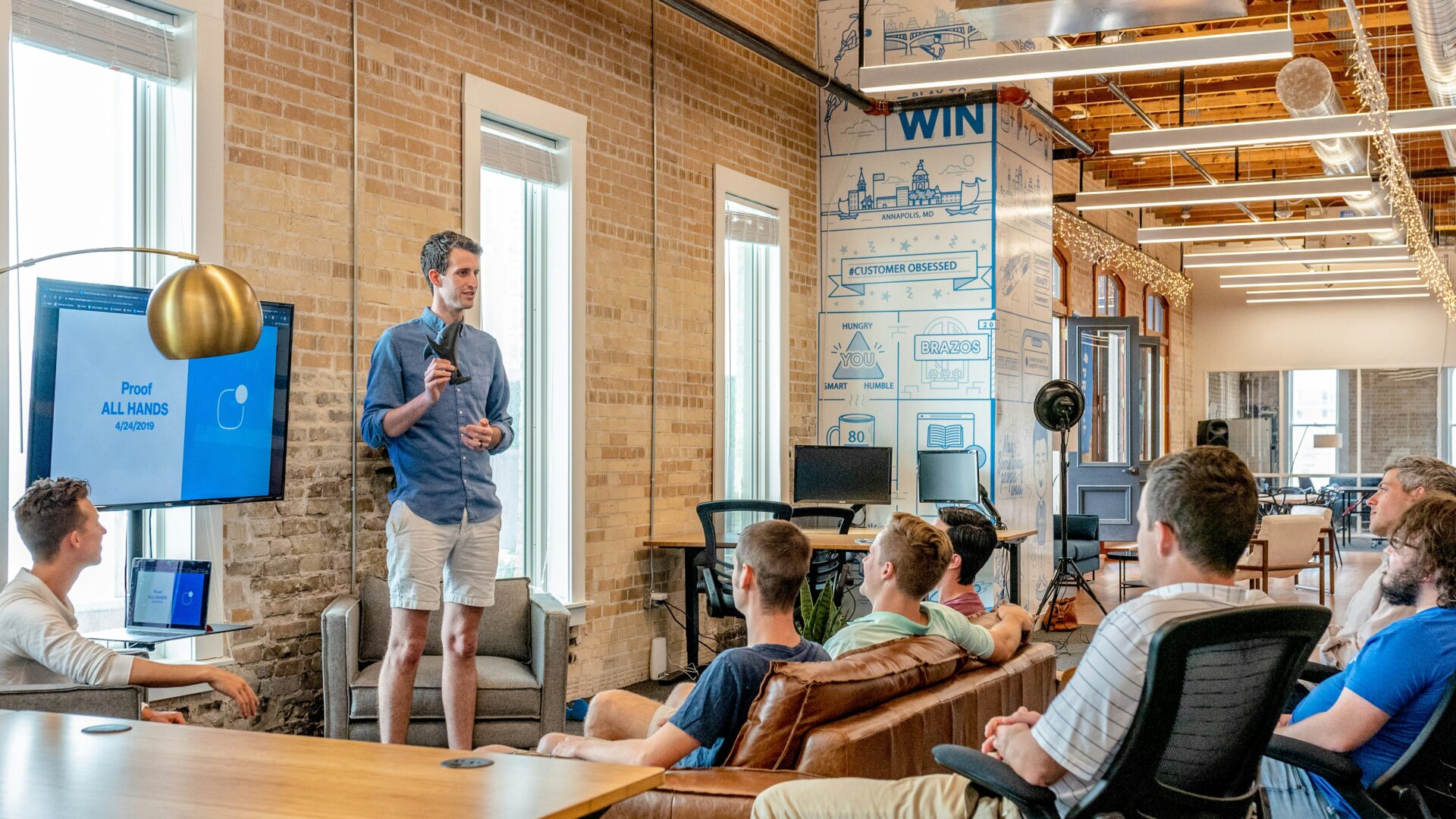 people watching a man giving a presentation
