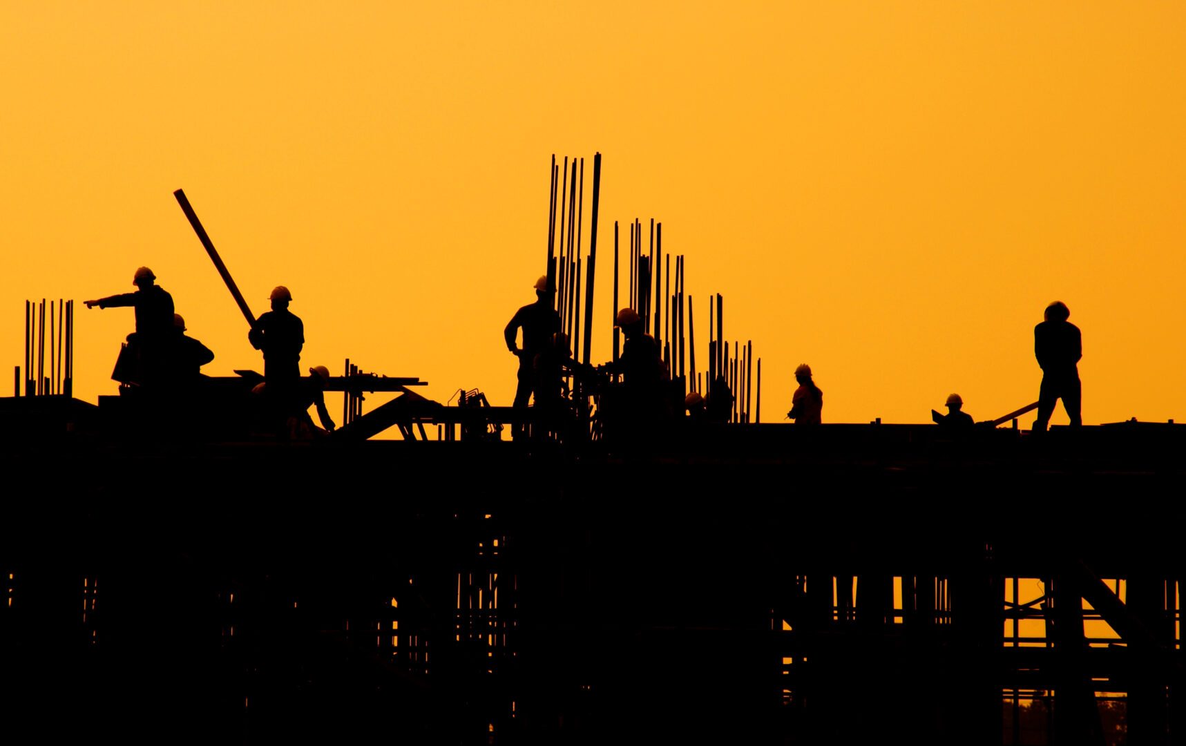 construction workers at sunset