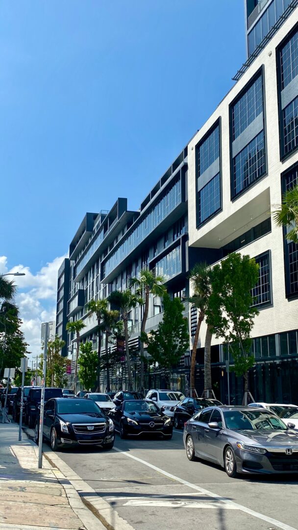 cars on a road in front of a building